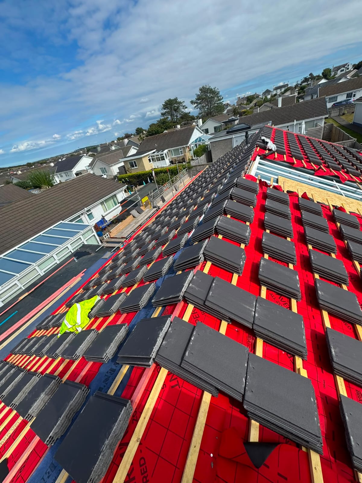 Full roof replacement in progress with new breathable membrane and stacked tiles