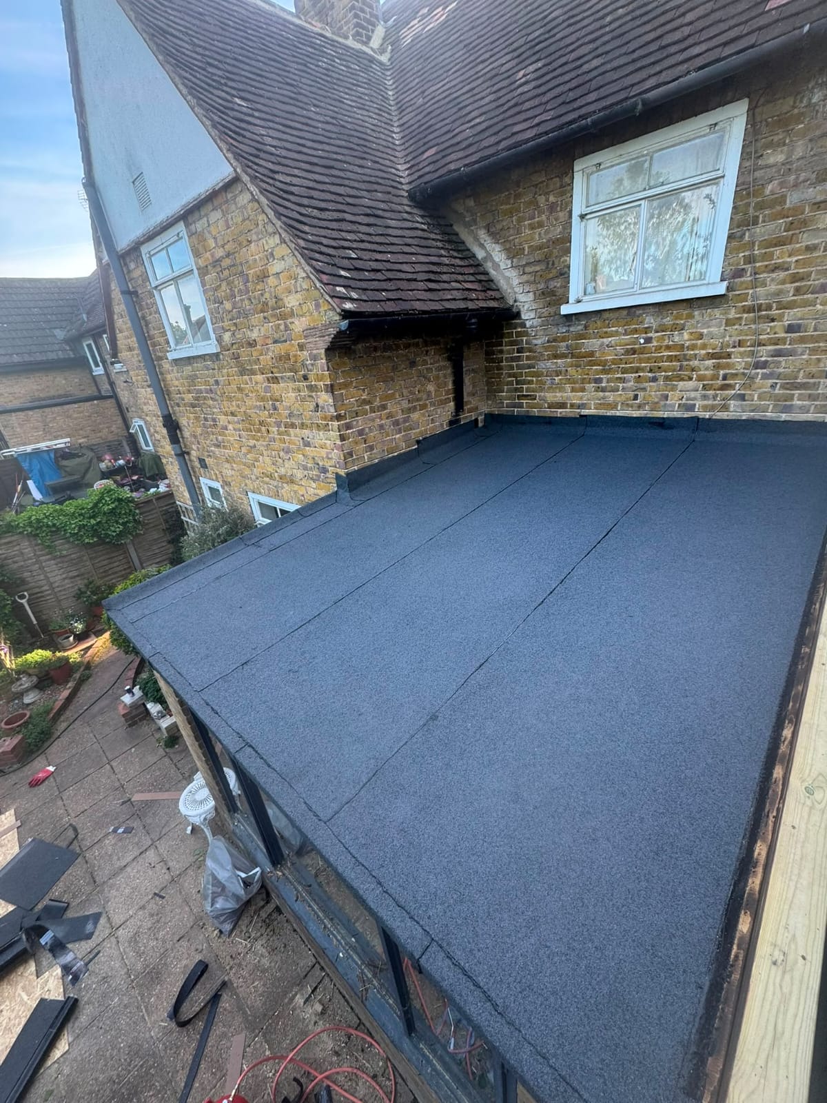 Newly laid felt flat roof covering on a rear extension
