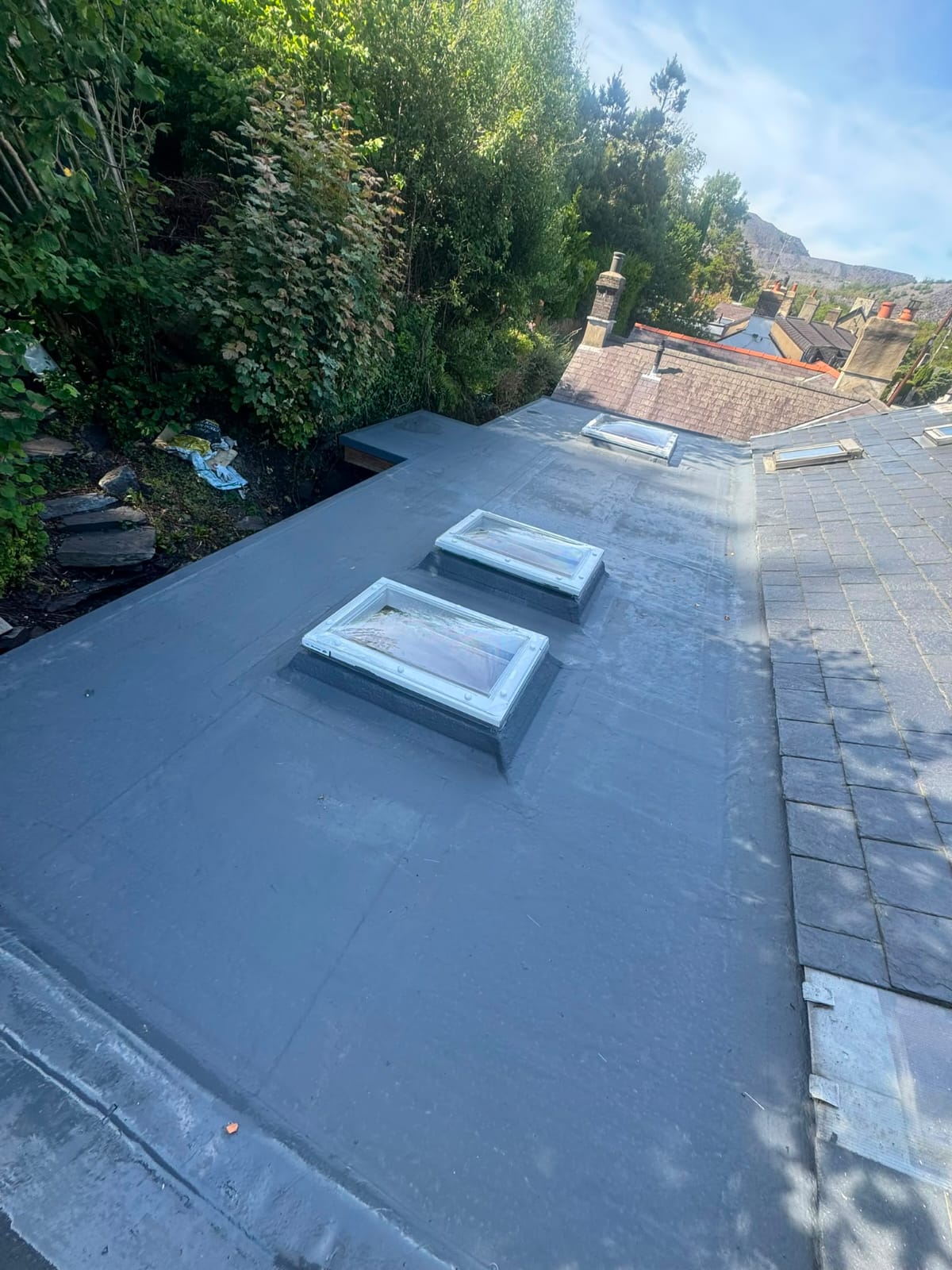 Completed flat roof replacement with clean seams and new edge trims