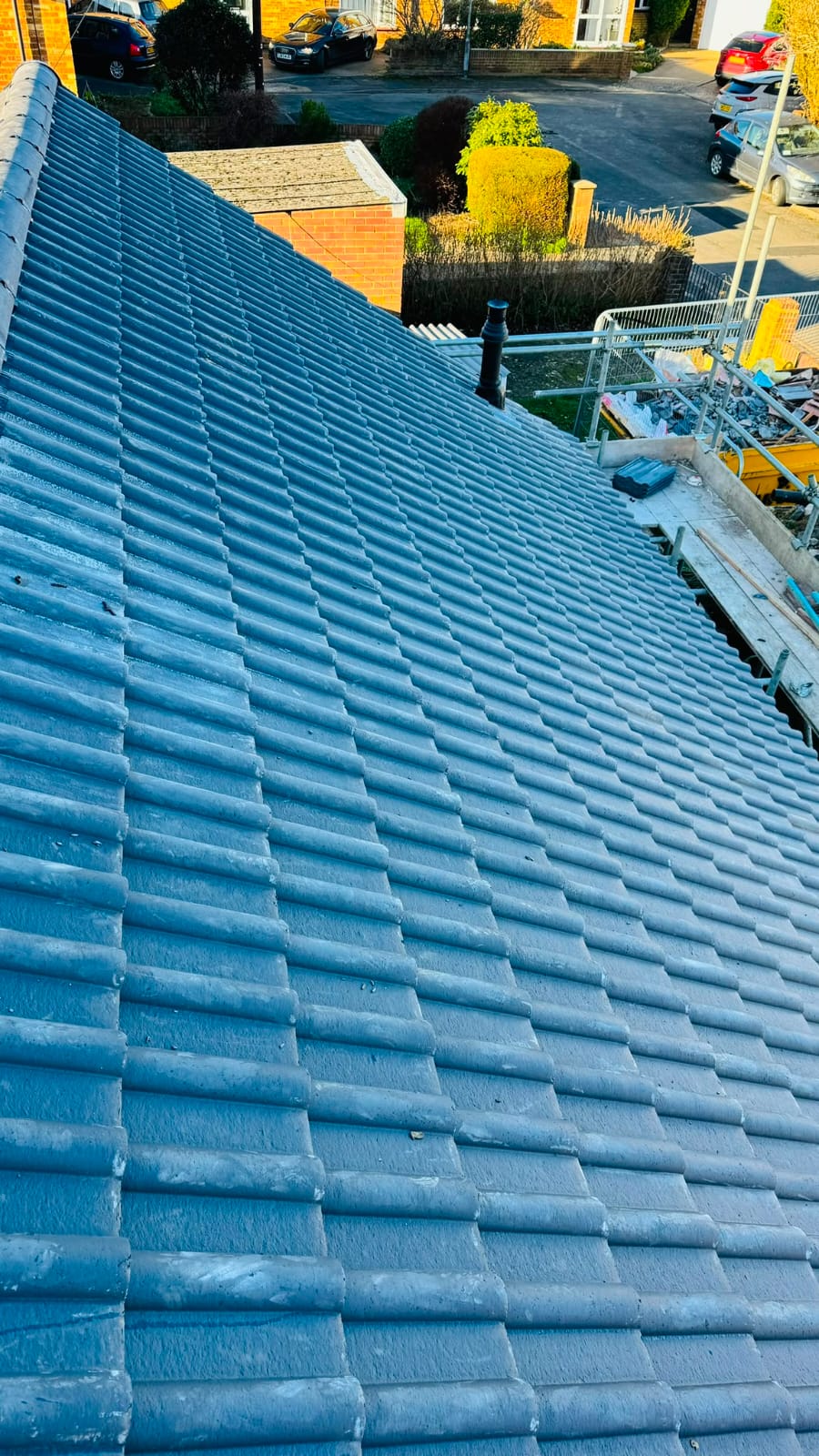 Completed tiled roof with new ridge tiles and guttering in North Wales