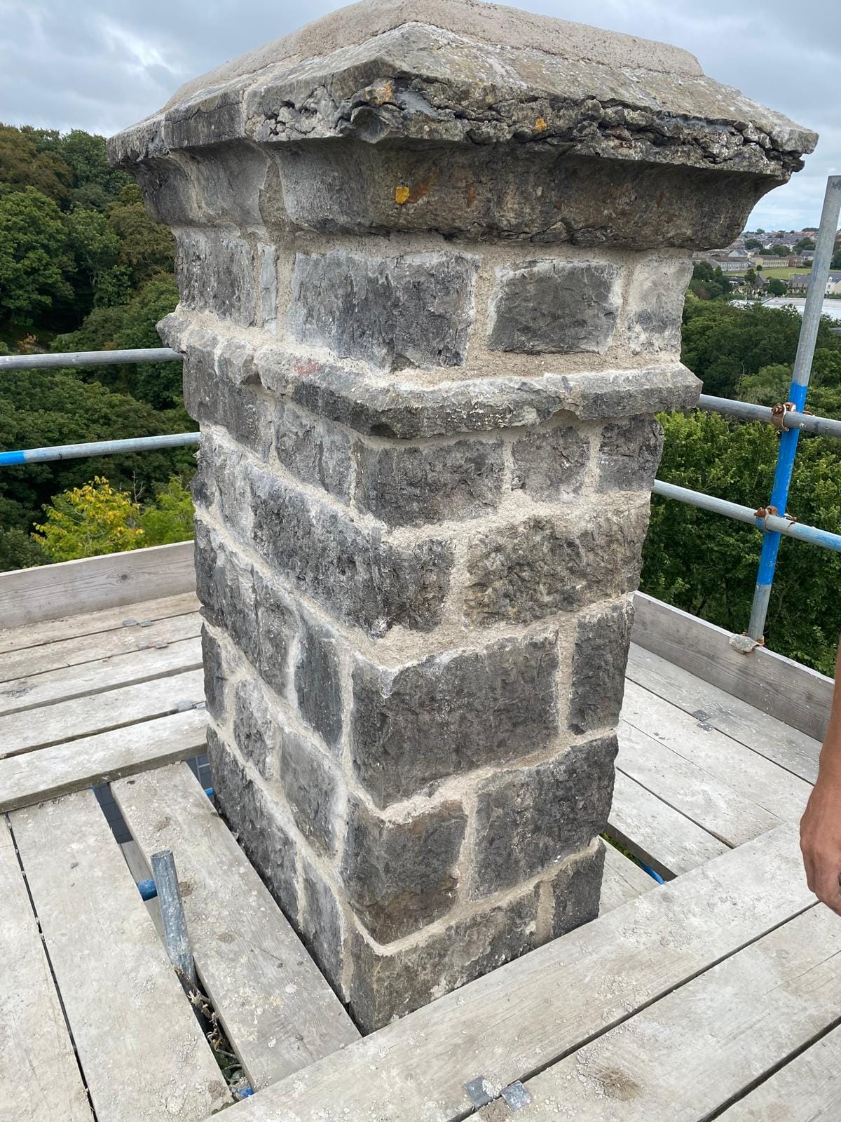 Damaged chimney stack before repair by North Wales Roof Repairs in North Wales