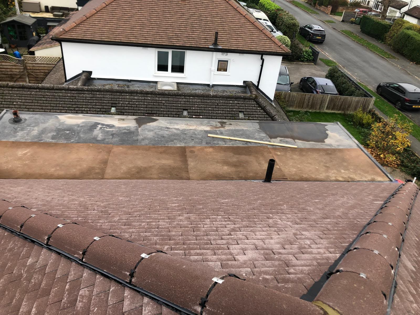 Completed flat roof replacement with clean seams and new edge trims